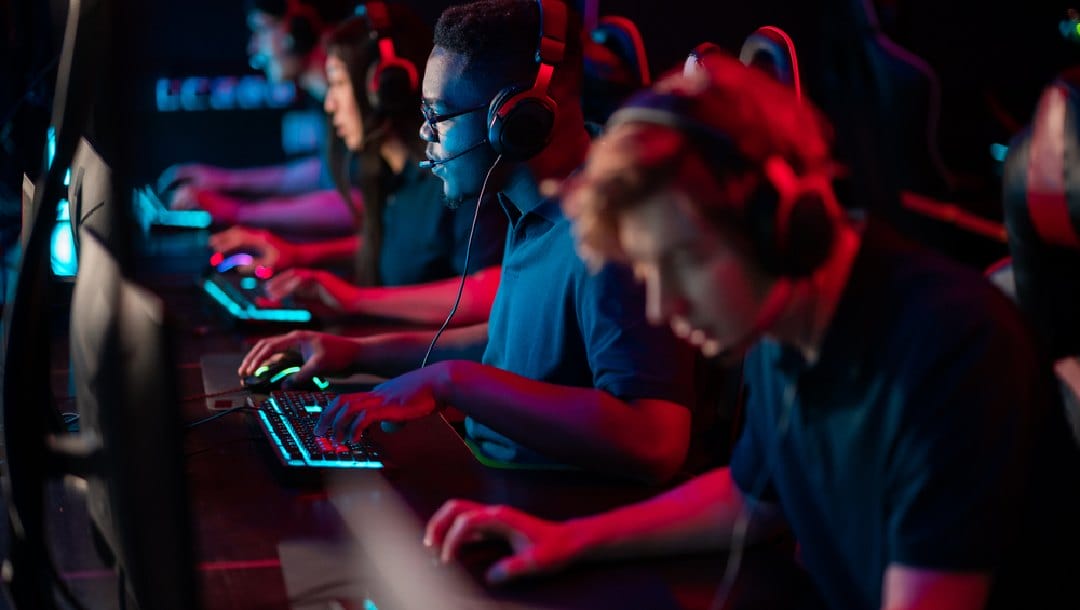 An esports team concentrating on their computers