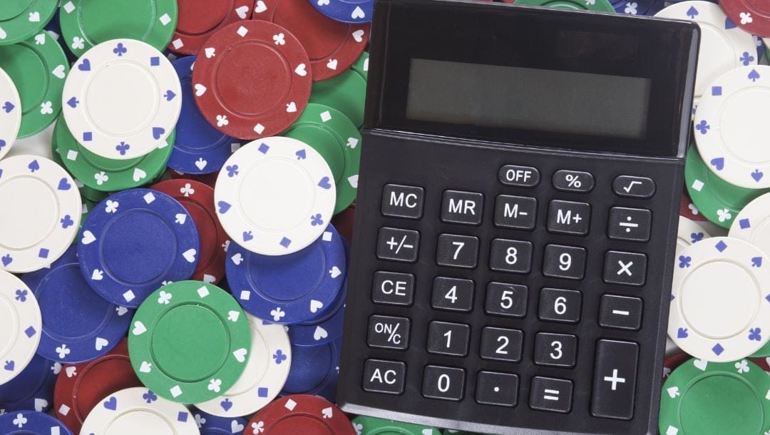 a top view of a calculator among poker chips