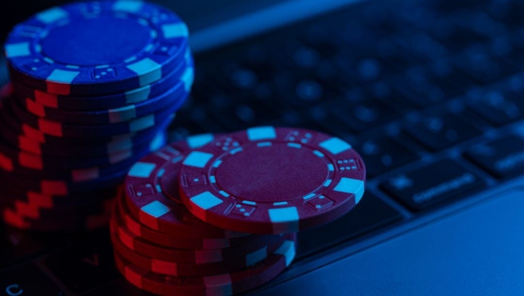 poker chips stacked on a laptop keyboard