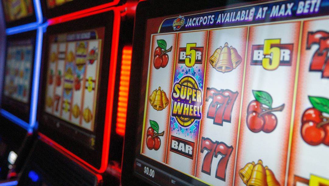 close up of slot machines lined up next to each other in a casino