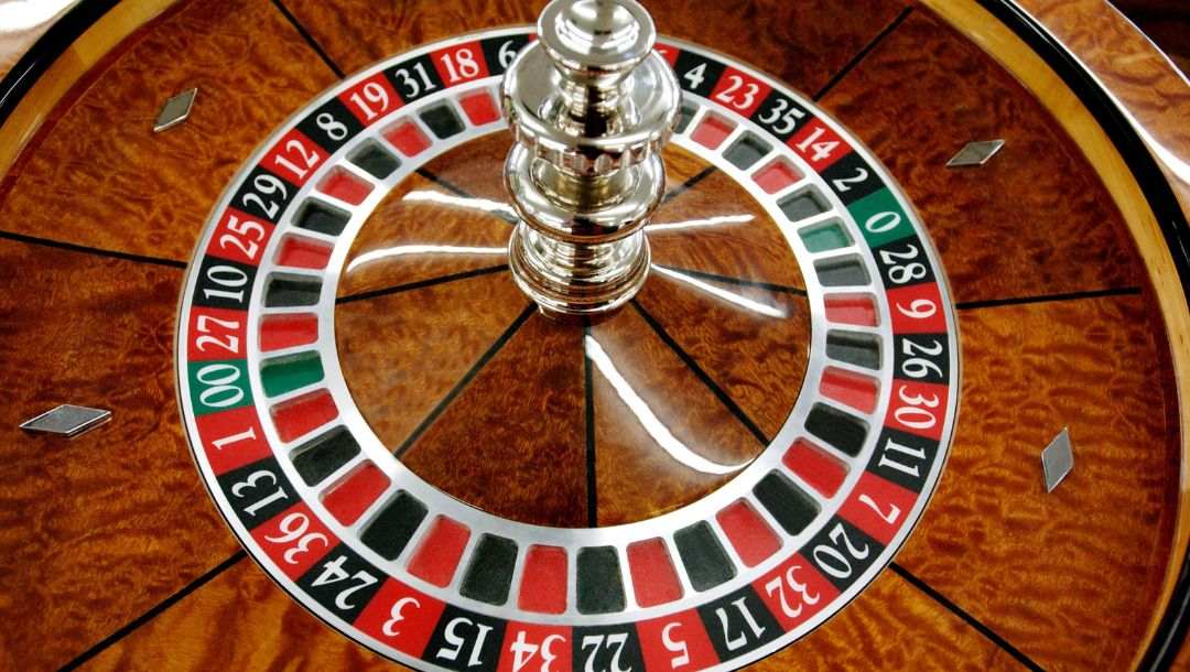 close up of a wooden roulette wheel in a casino