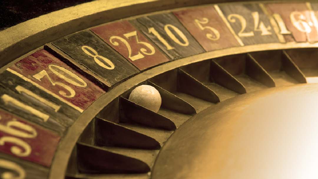 An old, dusty roulette table with a ball