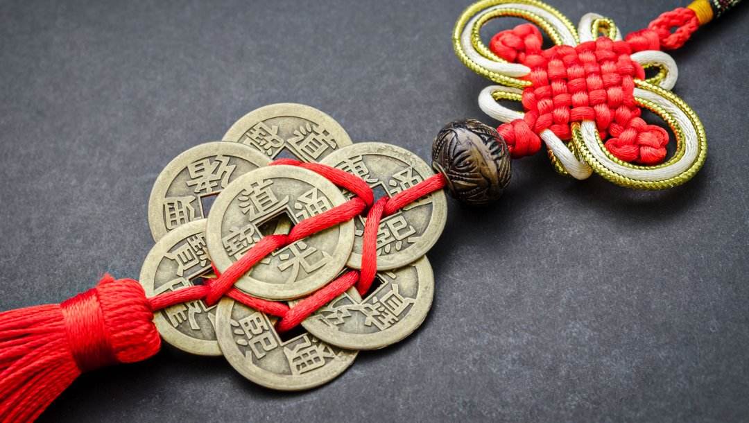 A lucky charm made of red rope and Chinese coins.