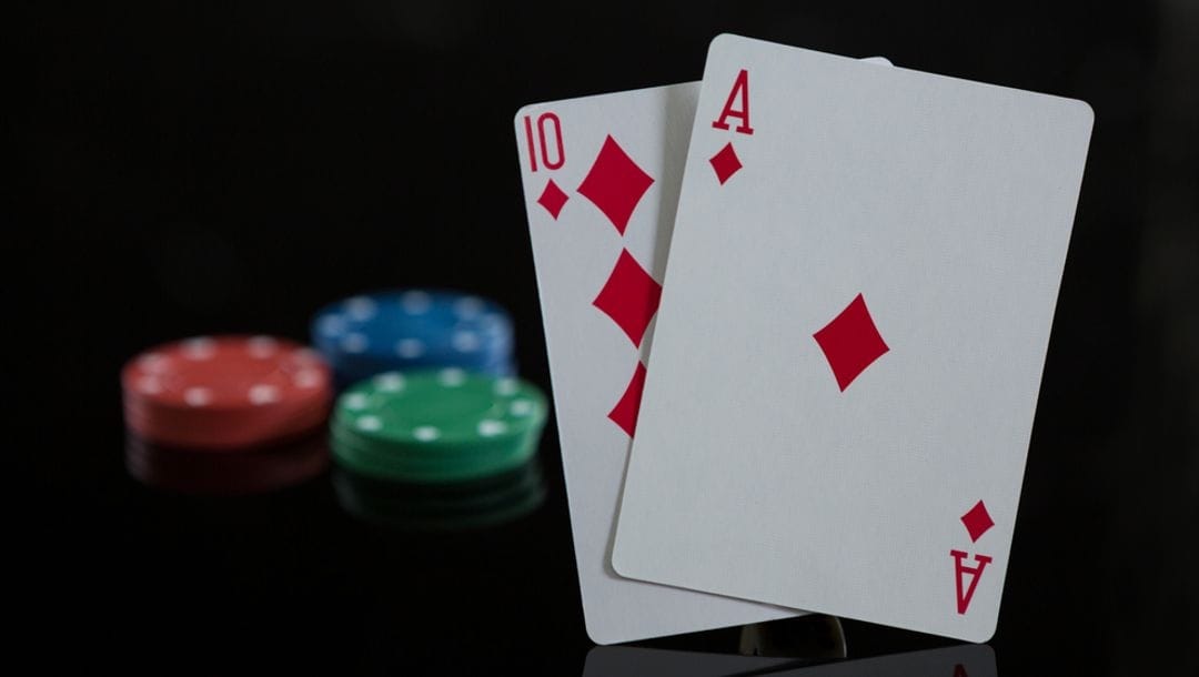 An ace of diamonds and 10 of diamonds featured against casino chips.