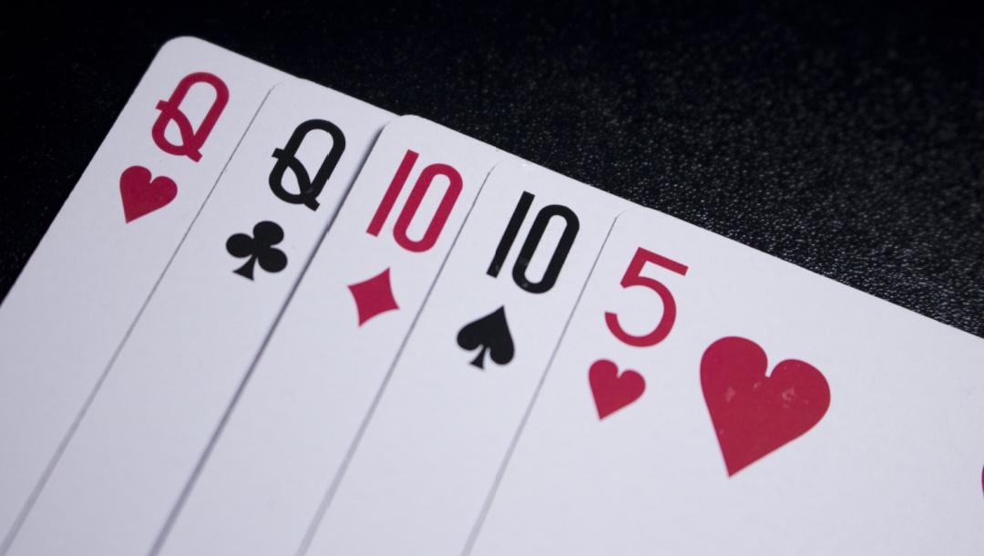 A poker hand with two queens, two tens and a five