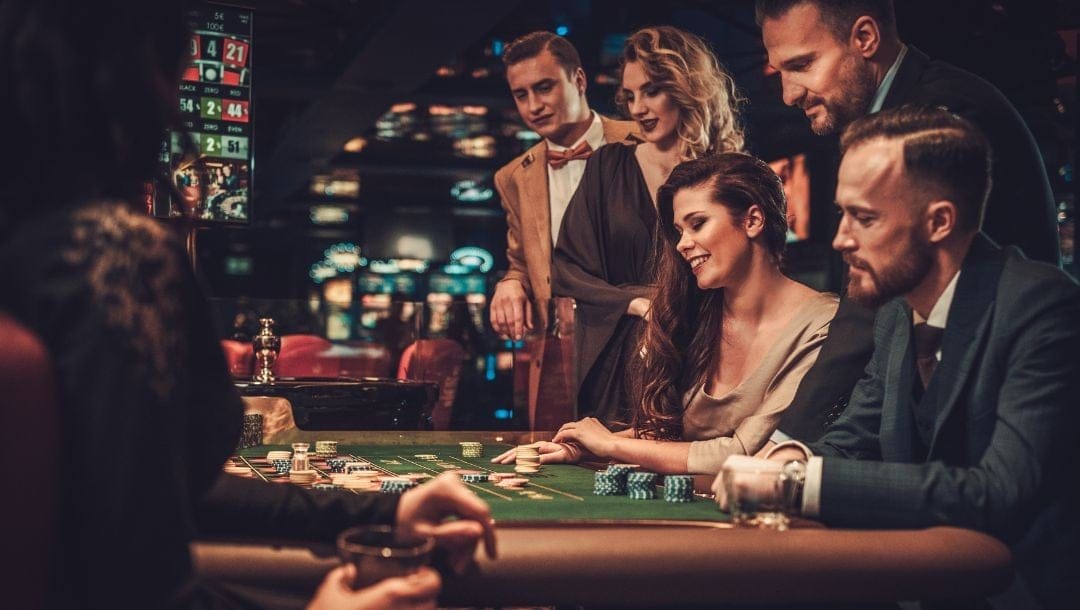 A group of elegantly dressed individuals gathered around a poker table, engaged in a game of poke.