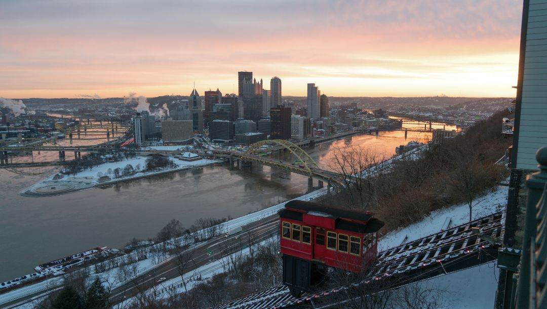 Sweeping views of Pittsburgh's skyline along the merging rivers with the Duquesne incline trolley cart and track.