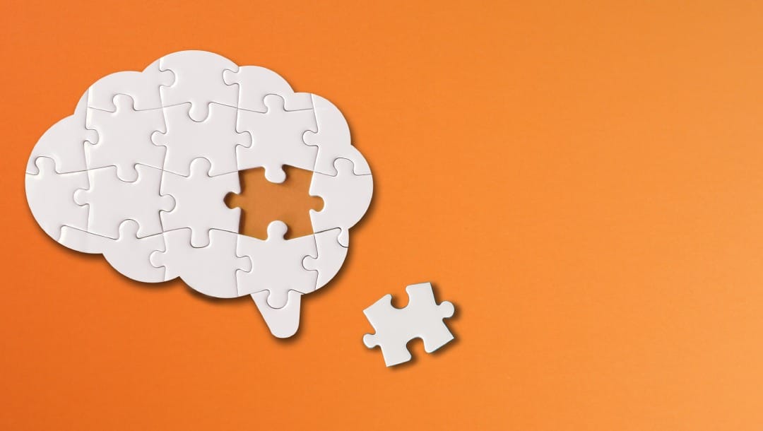 Brain puzzle on an orange background.