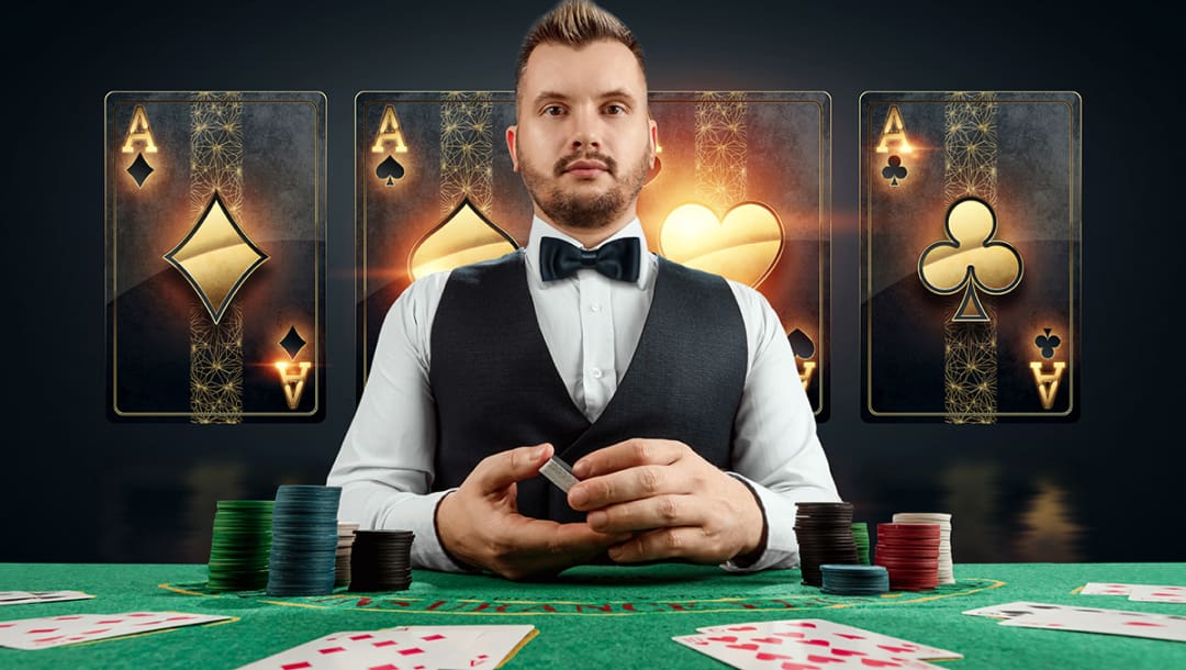 A poker dealer is holding playing cards. There are four black and gold playing cards against a black screen behind the poker dealer. He is sitting in front of a green felt poker table. There are poker chips and playing cards on the table.