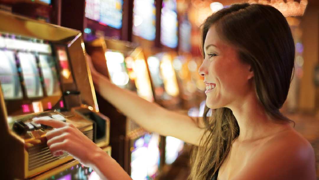 A woman playing at a slot machine at the casino