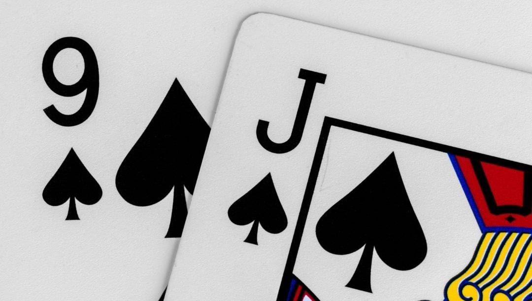 close up of a jack and nine of spades playing cards