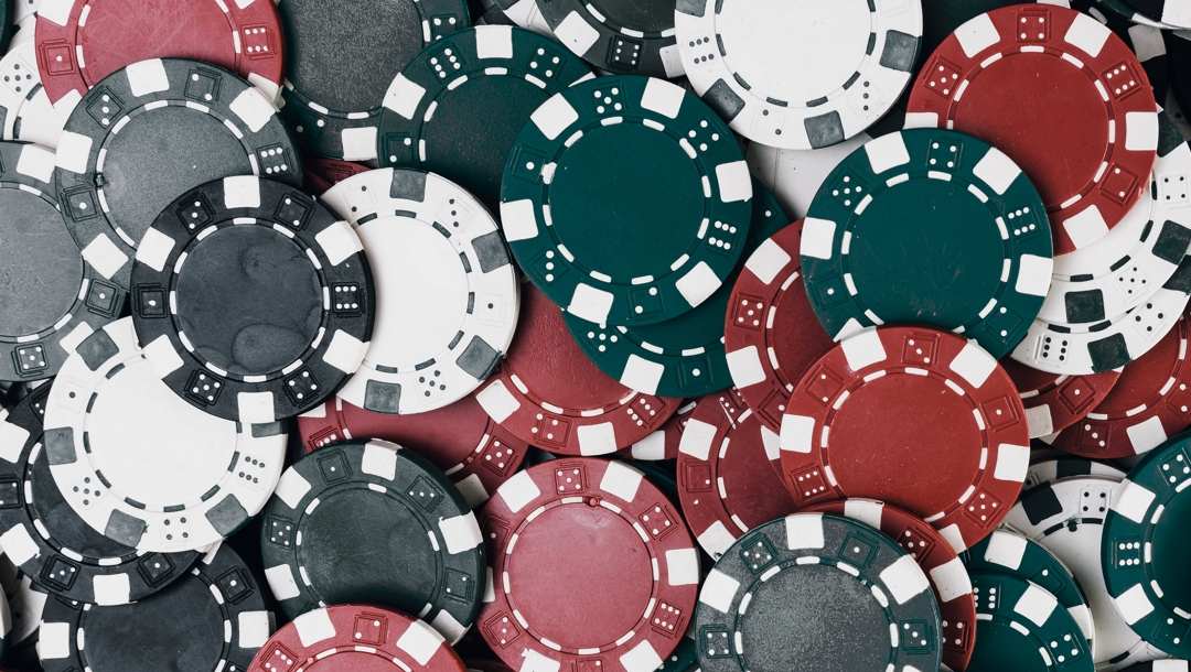 Green, red, black, and white poker chips