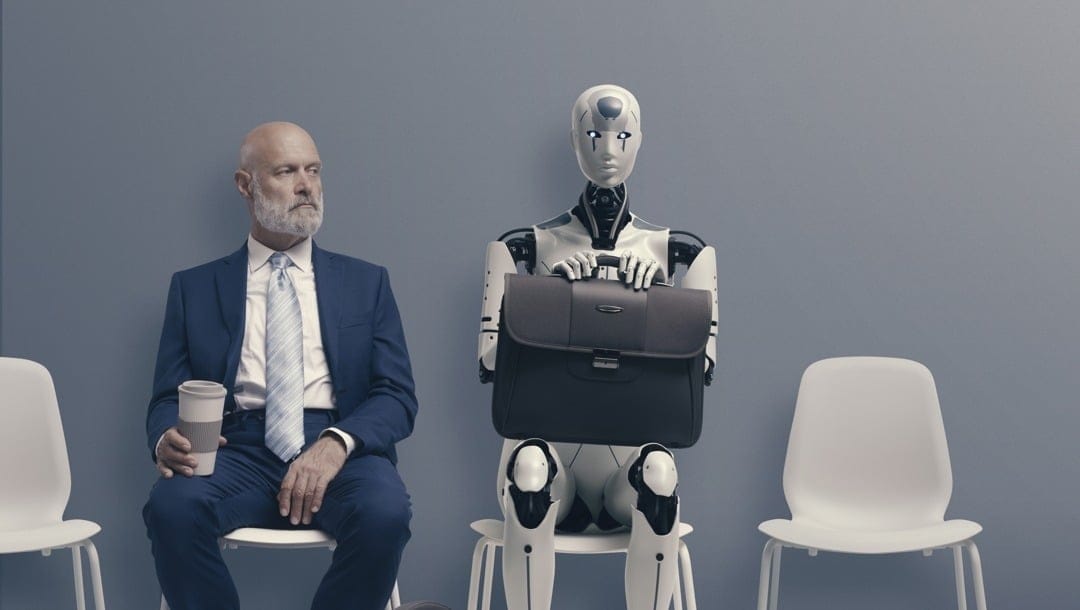 A man sits next to a robot in a waiting room