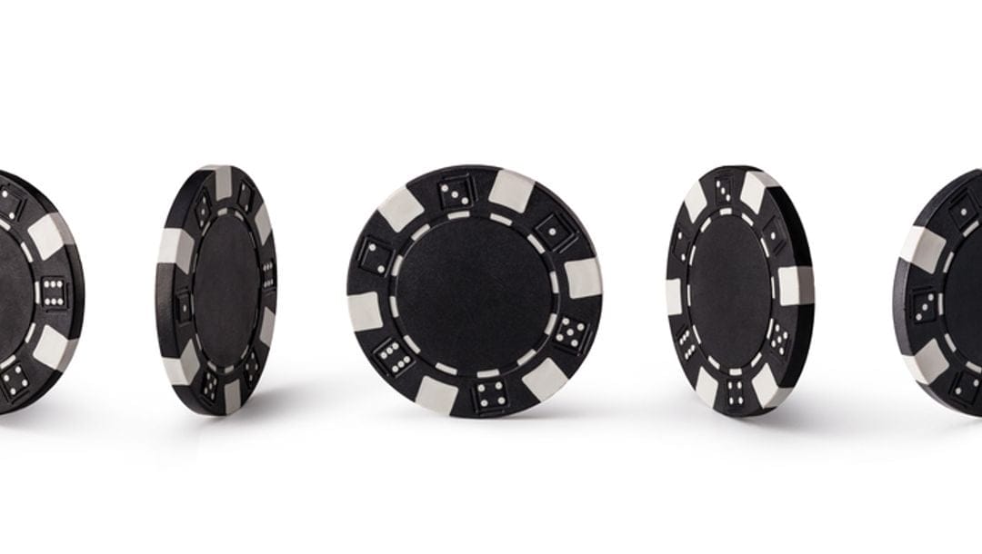 Black poker chips displayed in every angle.