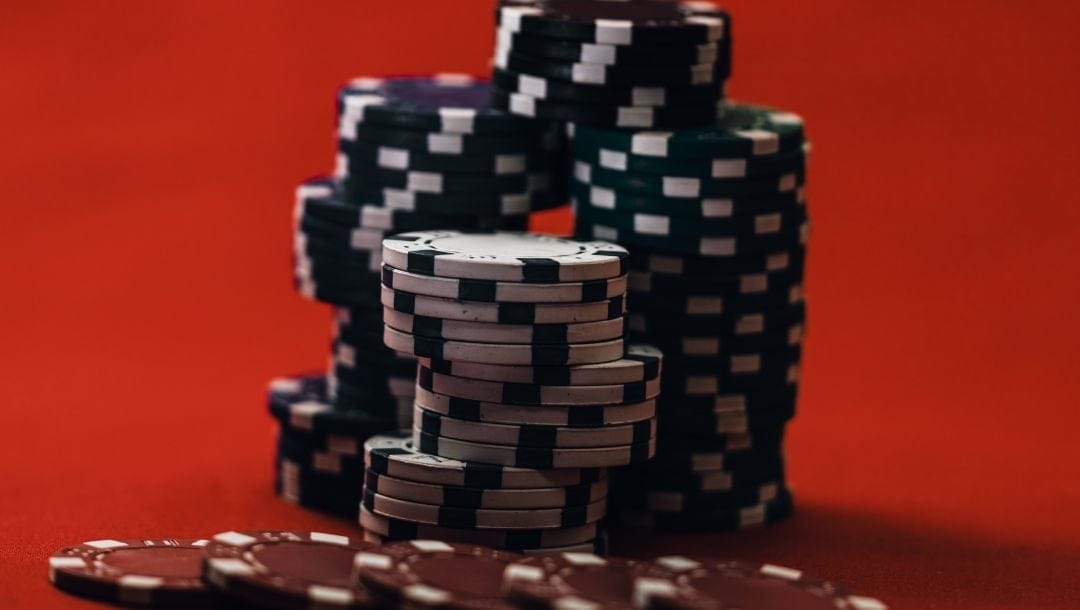 Stacks of white, green, black, and red casino chips.