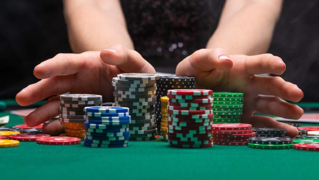 A poker player pushing chips onto the middle of the table