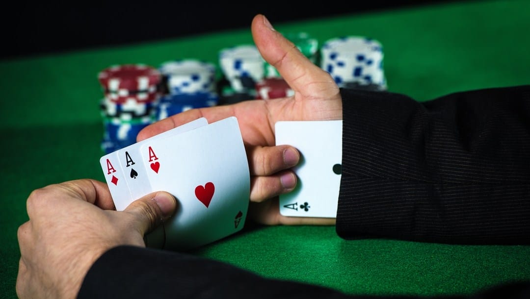 Man with ace up his sleeve, cheating at poker