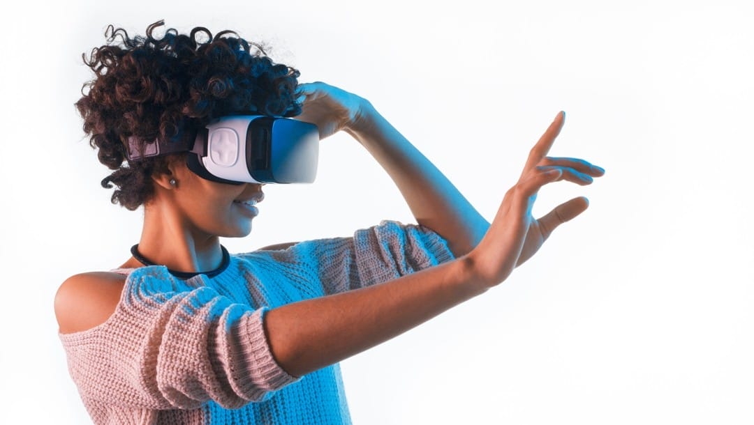 Woman touching air wearing VR headset white background