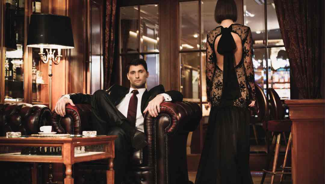 Two people in formal attire in a lounge.