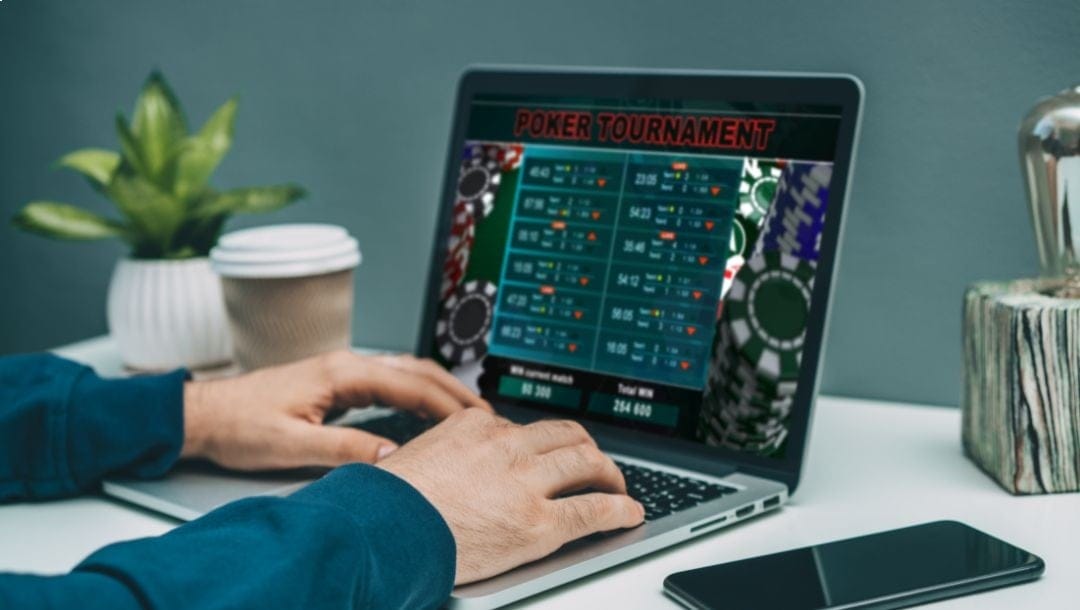 Man playing online poker on his laptop.