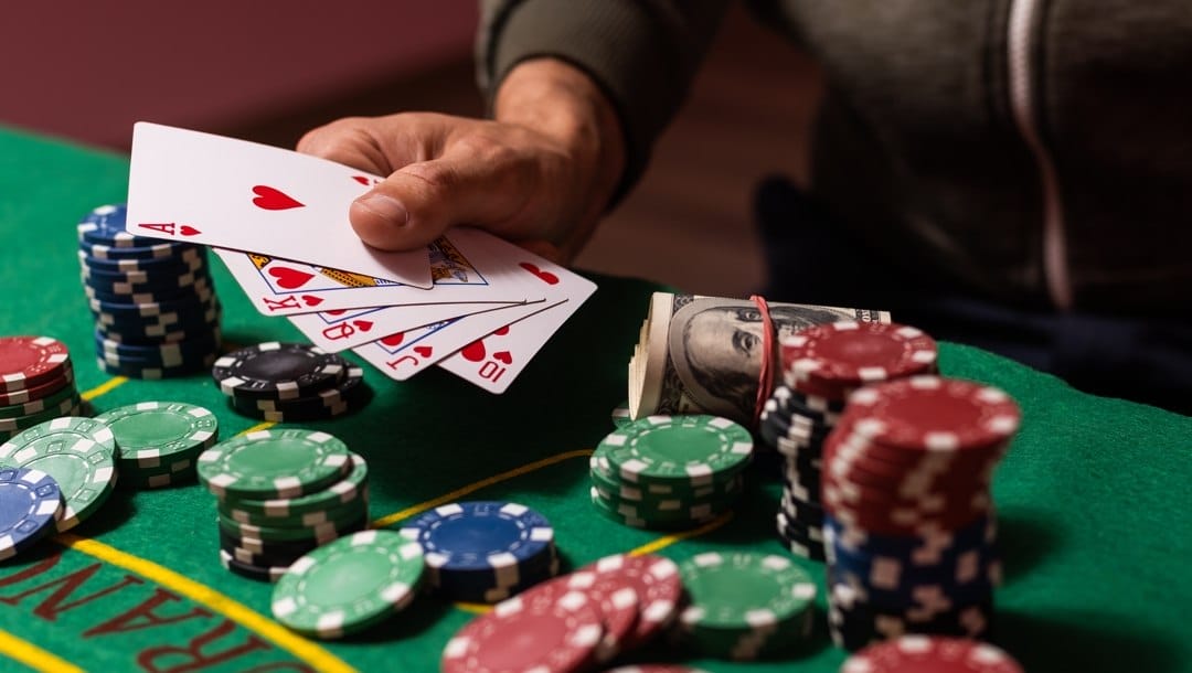 Man playing blackjack at the table with cards and betting chips