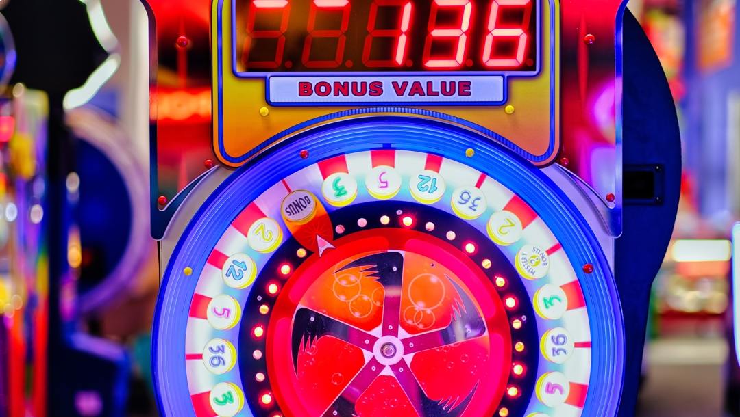 Colorful spin wheel of fortune game with digital score display.
