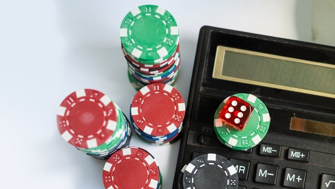 View of calculator among gambling chips
