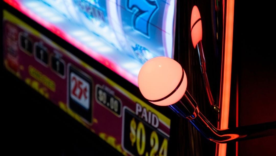 Close-up view of a slot machine featuring the handle ready to be pulled for a spin.