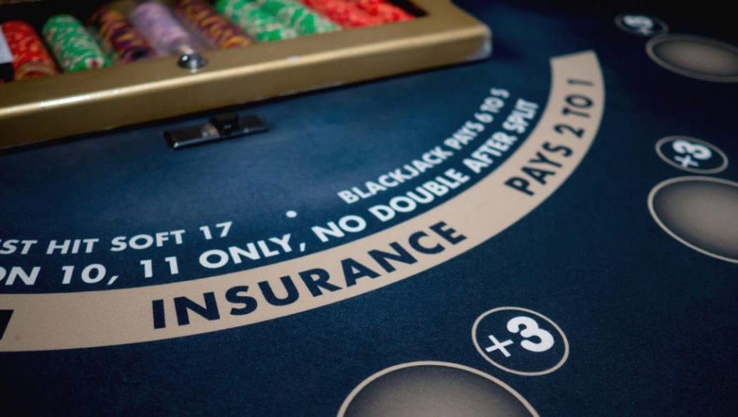 A closeup of the insurance payouts banner on a blackjack table.