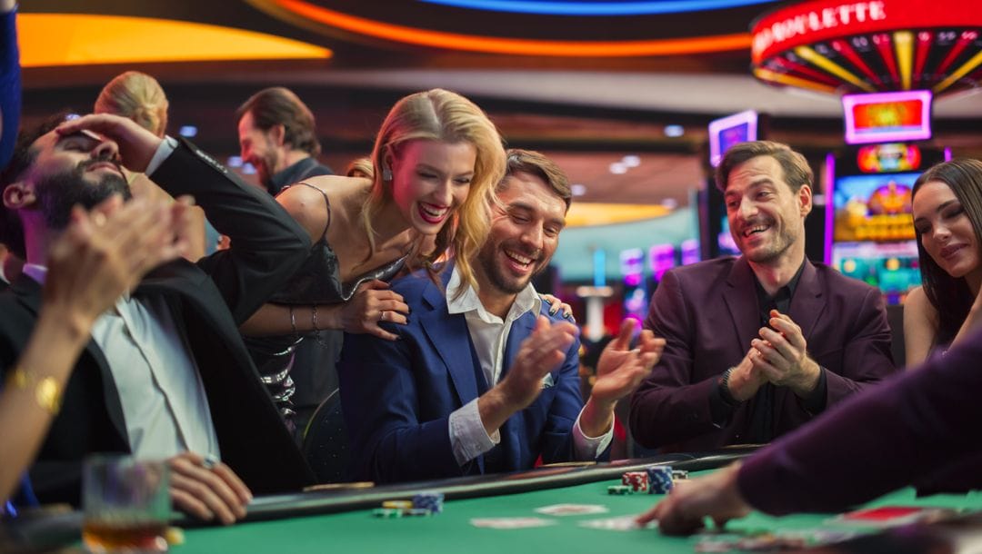 Happy gamblers celebrating at a casino table.
