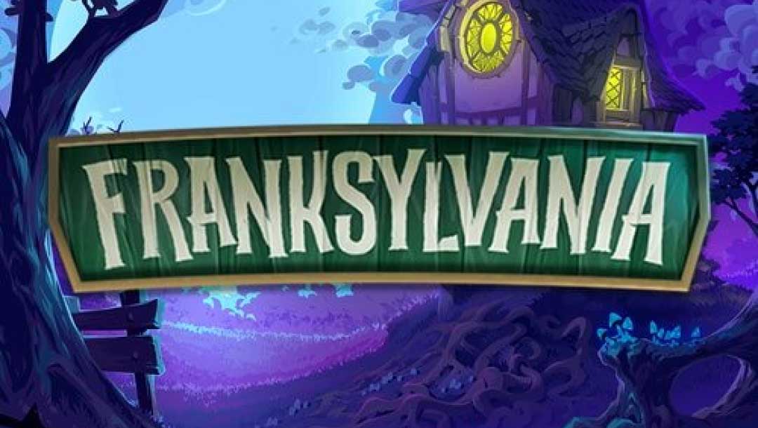 Franksylvania online slot screen featuring the game logo “Franksylvania” written across a green wooden board, against an eerie forest backdrop with a cartoon cottage that has yellow lights shining from the window.
