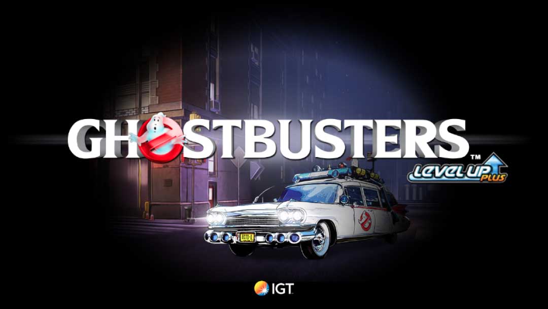 The Ghostbusters Plus title screen featuring the game’s logo on top of a picture of the Ectomobile outside of the Ghostbusters headquarters, lit up by a spotlight.