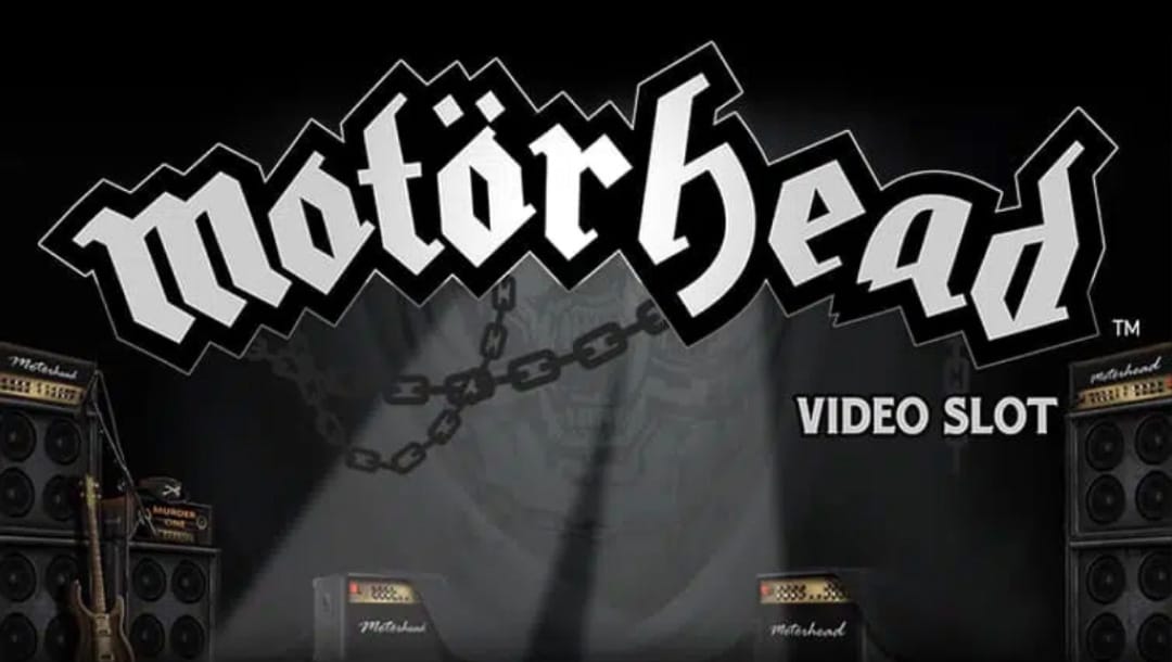 The Motörhead logo, on a dark live music stage, featuring amplifiers, a guitar, a microphone, and chains, with a spotlight.