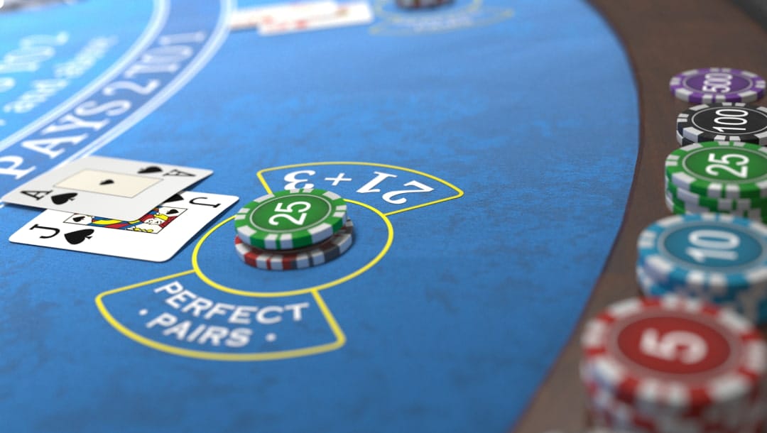 A screenshot of the Detroit Lions Blackjack gameplay, $25 in casino chips has been placed on the blue table and an Ace and Jack are next to it.