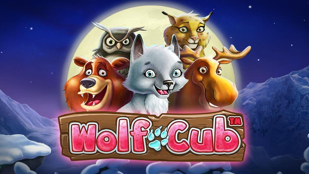 The Wolf Cub online slot game logo is in red and turquoise across a wooden plank. Above the logo, animated animals such as a moose, wolf, owl, leopard, and bear are shown, with a giant silver moon behind them. The background shows the night sky with stars and a snowcapped mountain.