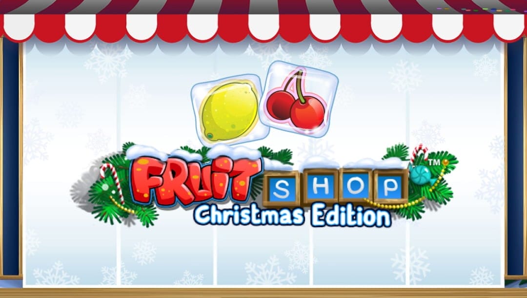 The Fruit Shop Christmas Edition title screen. The backdrop is a snowy design under a red and white awning. In the center of the backdrop are the words “Fruit Shop Christmas Edition” surrounded by Christmas tree leaves. A lemon and cherries in ice cubes are visible above the game’s title.