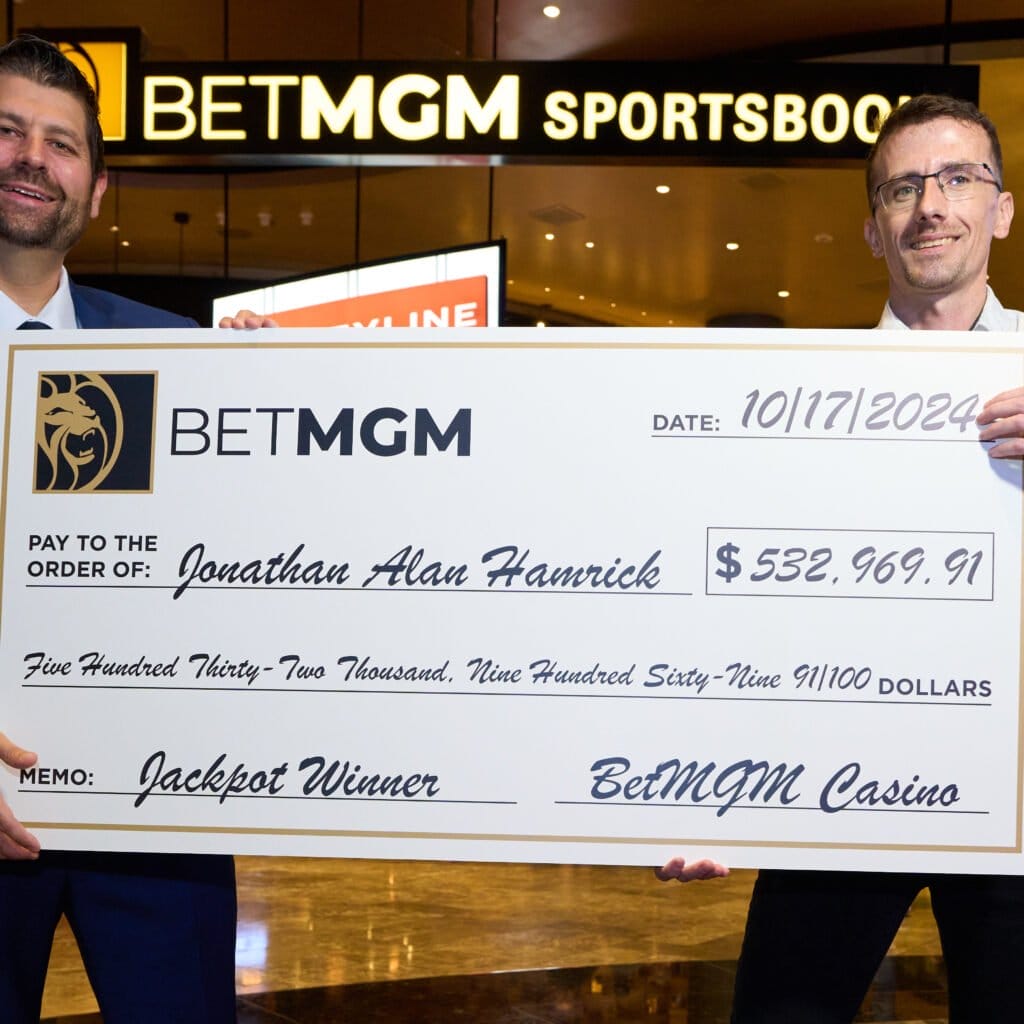 BetMGM Director of VIP Casino Mike Vricella presents a check to Jonanthan Hamrick who won a $532,969 jackpot at BetMGM Casino in West Virginia. 