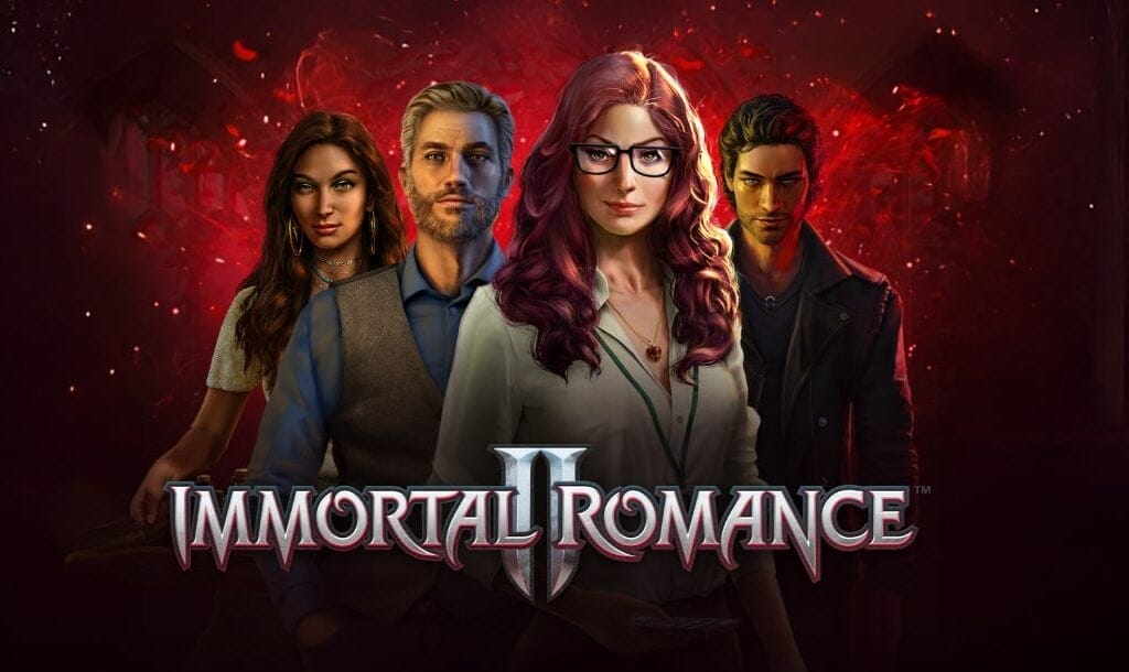 The title screen for Immortal Romance II. The four characters, Amber, Troy, Michael, and Sarah, stand behind the game logo with serious, but mischievous expressions on their faces. The background is dark with a glowing red section in the middle and small embers scattered around the image.