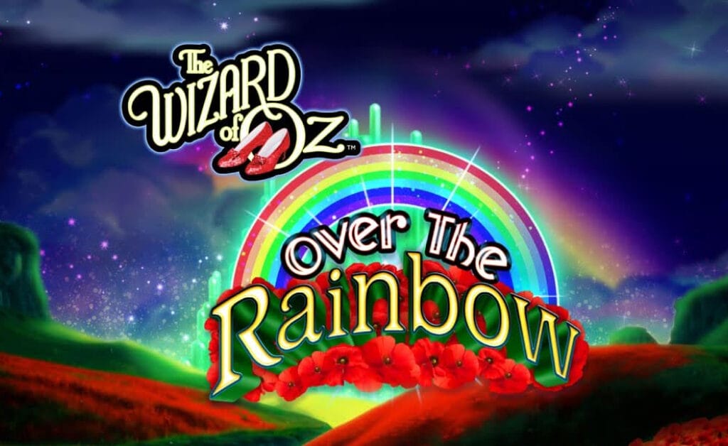 The Wizard of Oz Over the Rainbow title screen. The background is lush green hills with fields of red poppies. Above the hills is the night sky with picturesque clouds. Bright colors and balls of light are visible in the distance. In the foreground is the game title and logo featuring a rainbow and red poppies behind the text “over the Rainbow”.