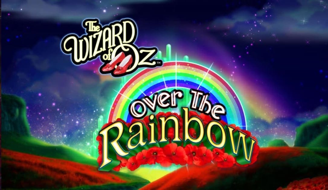 The Wizard of Oz Over the Rainbow title screen. The background is lush green hills with fields of red poppies. Above the hills is the night sky with picturesque clouds. Bright colors and balls of light are visible in the distance. In the foreground is the game title and logo featuring a rainbow and red poppies behind the text “over the Rainbow”.