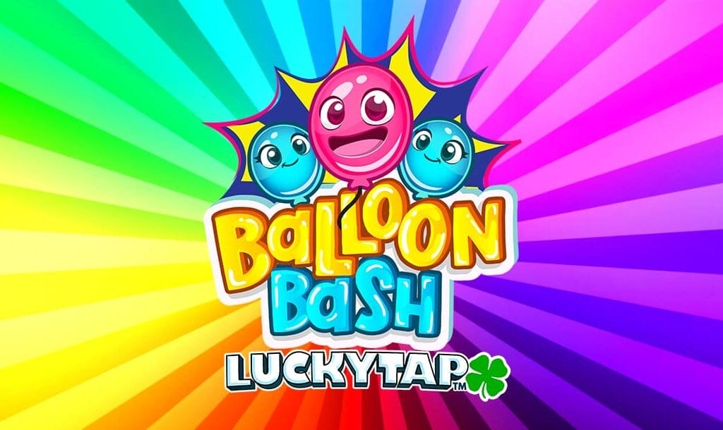 The Balloon Bash LuckyTap online slot game banner, featuring the title displayed in bold, playful yellow and blue letters with a cheerful pink balloon character in the center, accompanied by two smiling blue balloons. The background features a vibrant rainbow-colored radial burst pattern, creating a fun and energetic atmosphere. A green four-leaf clover icon is included next to the LuckyTap text.