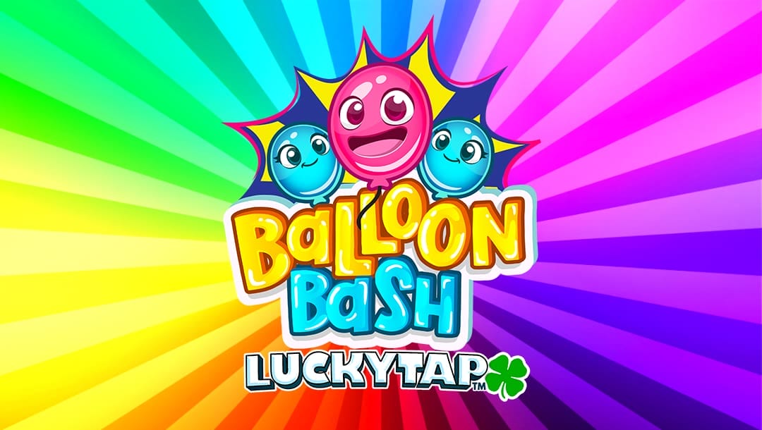 The Balloon Bash LuckyTap online slot game banner, featuring the title displayed in bold, playful yellow and blue letters with a cheerful pink balloon character in the center, accompanied by two smiling blue balloons. The background features a vibrant rainbow-colored radial burst pattern, creating a fun and energetic atmosphere. A green four-leaf clover icon is included next to the LuckyTap text.