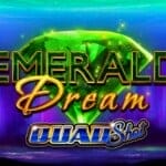 The Emerald Dream logo in front of a glittering green emerald against a colorful kaleidoscopic backdrop. The logo for the Quad Shot game mechanic is also visible, highlighting the specific variant of the game.