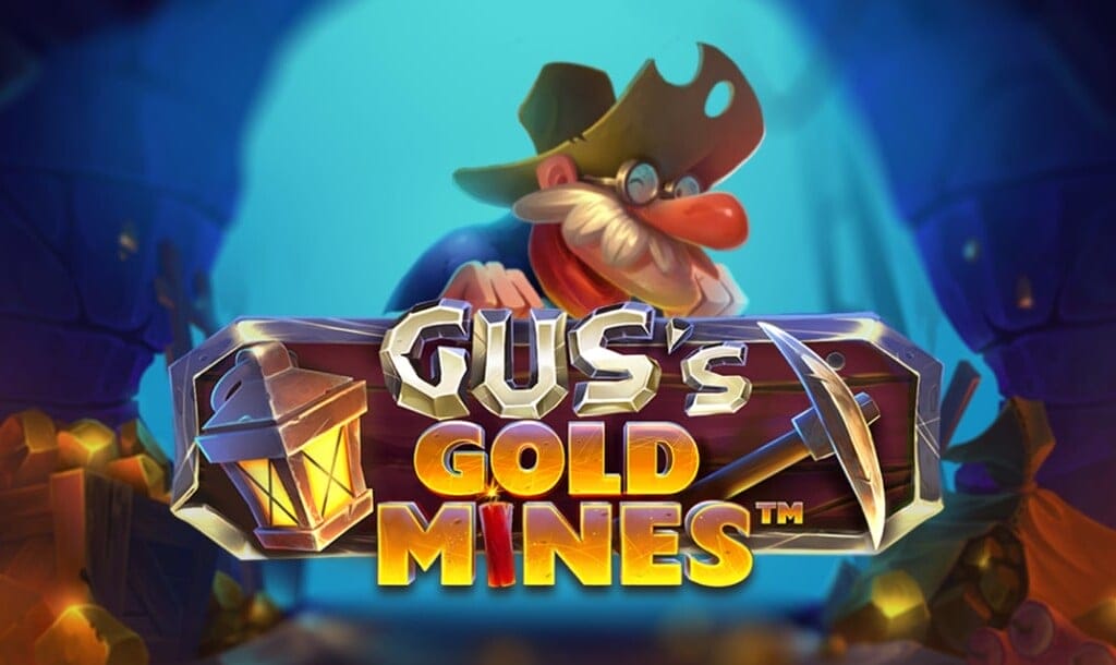 The Gus’s Gold Mines title screen featuring a cartoon miner with a long nose, glasses, and a toothy grin peering out from a mine tunnel. The game title appears in bold letters on a wooden sign, with a lantern and pickaxe flanking the words Gus’s Gold Mines, lit by glowing gold nuggets scattered around the entrance.