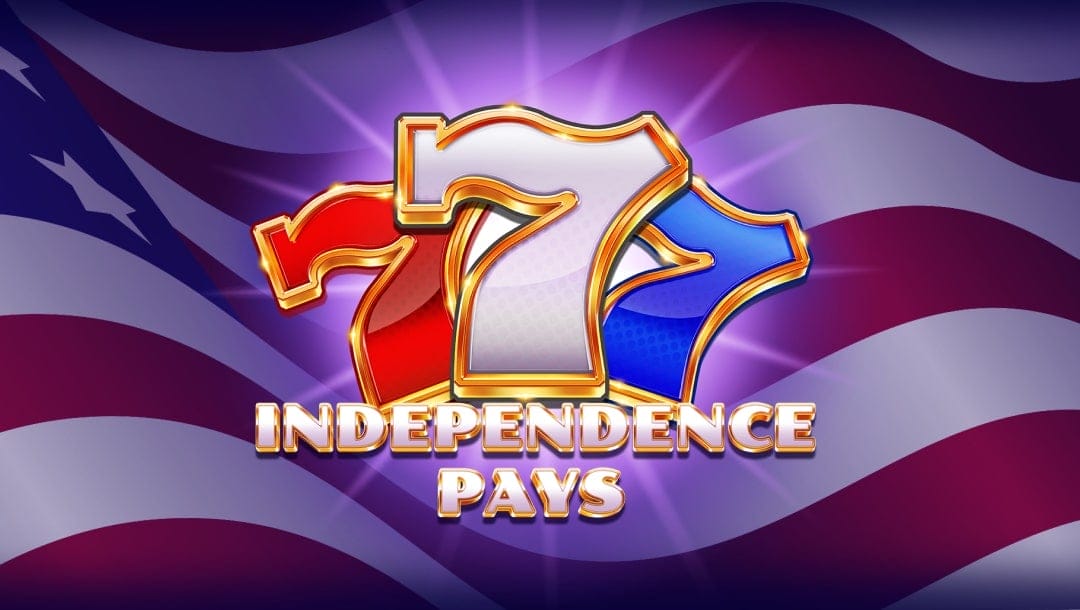 The Independence Pays slot banner. The background is a close-up of an American flag as it waves in the wind. In the foreground is the game logo. It features a red, white, and blue seven with a gold border. The game title is below the three sevens and is captured in a white font with a gold border.