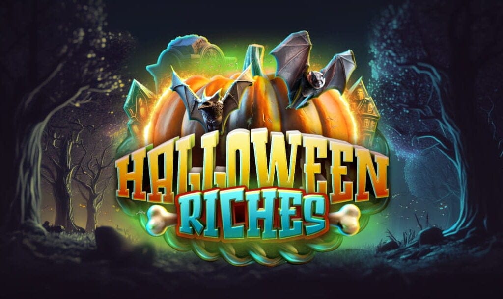 The Halloween Riches logo features bats, pumpkins, and other Halloween-themed symbols. A neon green hue surrounds the title and symbols. The background is a haunted forest with gnarly trees, with the darkness pierced by glowing shades of blue and yellow.