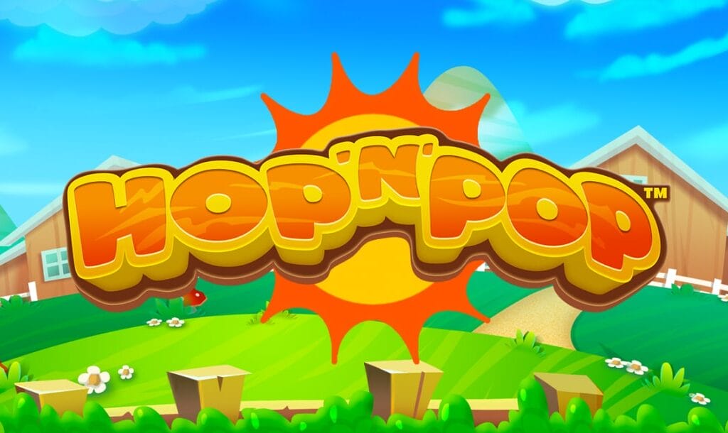 The title screen of Hop ’n’ Pop, featuring a bold, bubbly logo in orange and yellow gradient with a sunny farm backdrop. A giant stylized sun bursts from behind the logo, while lush green hills, white picket fences, red barns, and cartoon flowers decorate the peaceful rural landscape under a bright blue sky.
