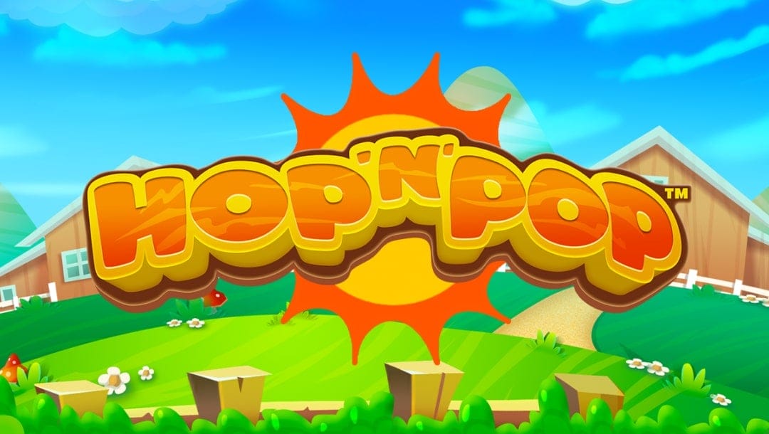 The title screen of Hop ’n’ Pop, featuring a bold, bubbly logo in orange and yellow gradient with a sunny farm backdrop. A giant stylized sun bursts from behind the logo, while lush green hills, white picket fences, red barns, and cartoon flowers decorate the peaceful rural landscape under a bright blue sky.