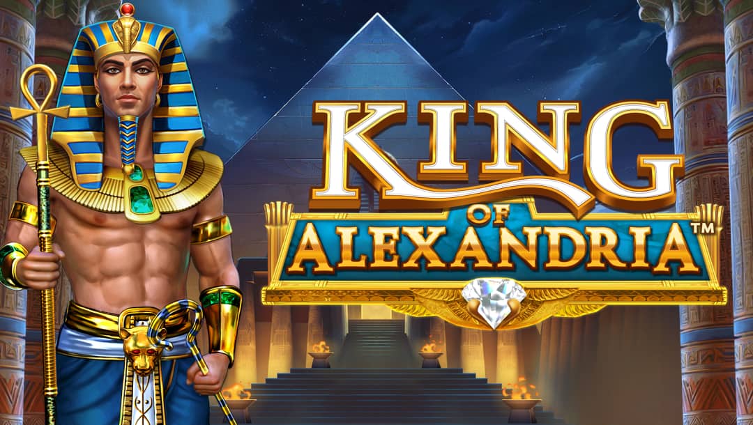 The banner image features the title screen of the King of Alexandria slot game. In the foreground, a muscular pharaoh dressed in traditional Egyptian royal attire with a blue and gold striped headdress, golden armbands, and a decorated staff stands prominently on the left. The game title King of Alexandria appears in large gold and blue lettering with an ornate gold frame and a sparkling diamond at the bottom center. In the background, an ancient Egyptian temple with towering columns, intricate hieroglyphic carvings, and warm, glowing torches lines the pathway leading up to a pyramid under a dark, starry night sky. The color palette is rich with gold and blue.