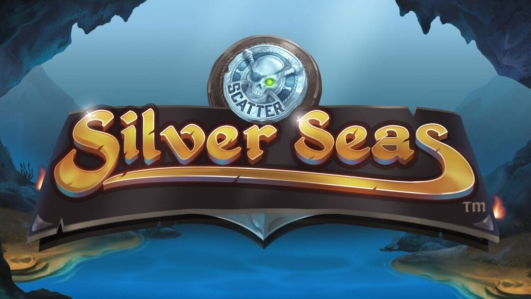 The game title Silver Seas appears in silver-edged gold letters on a curved wooden sign. Above the title is a skull with the word “Scatter” on it. The background is a cove on a misty tropical island.